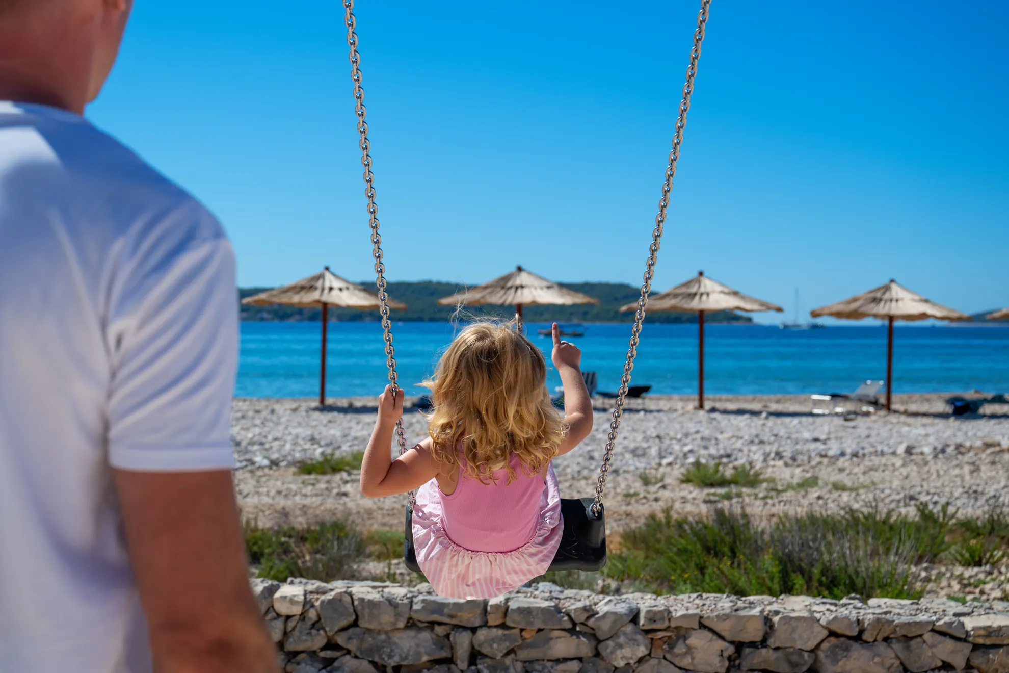 Kid on a Swing looking at the sea